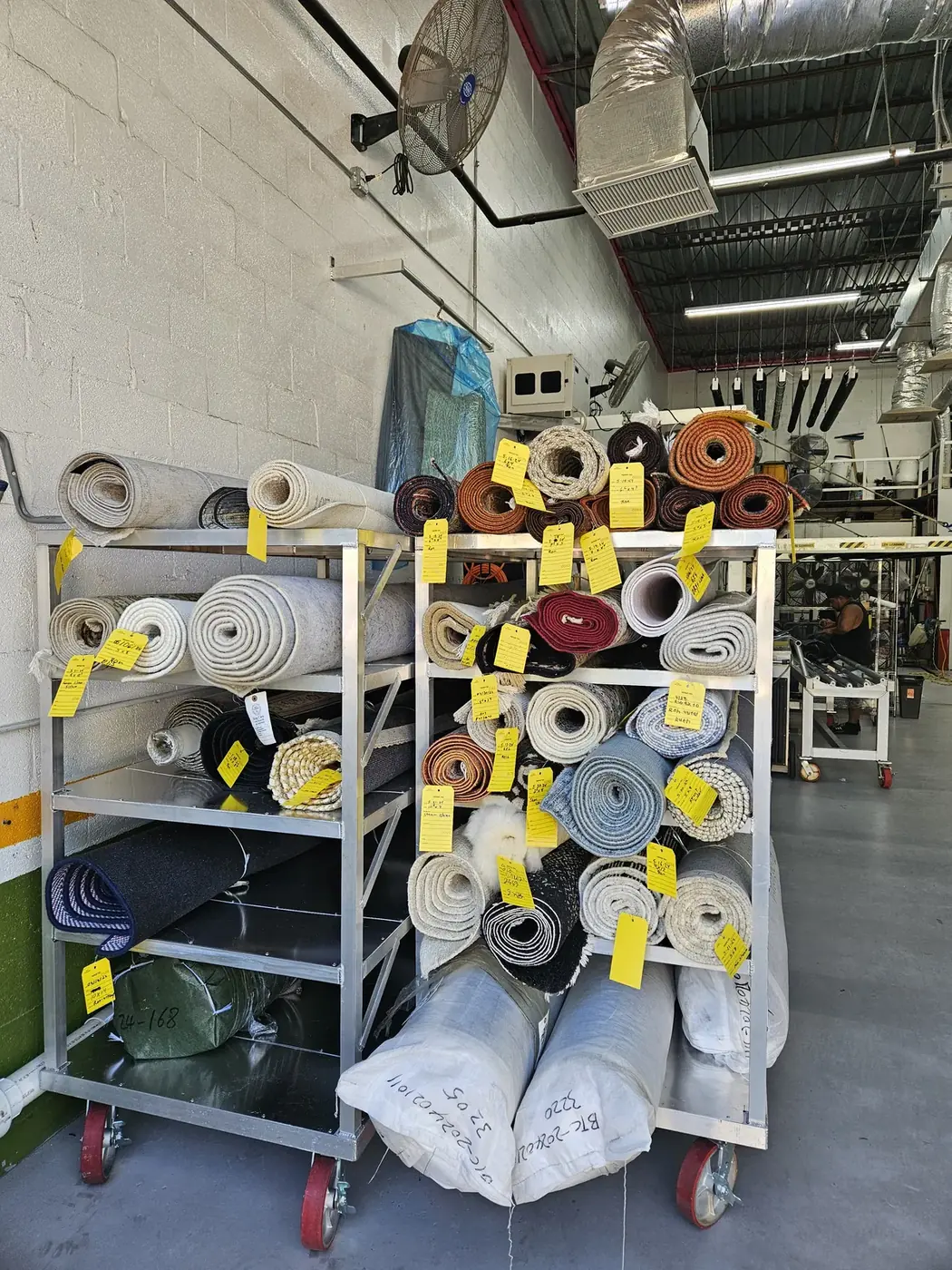 Rugs rolled, tagged and racked at the plant waiting their turn in the wash queue